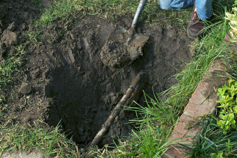 shovel digging up a water service line