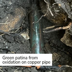 Green patina from oxidation on copper pipe